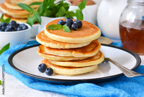 Homemade vanilla punkcakes with syrup and blueberries for breakfast. Good morning!