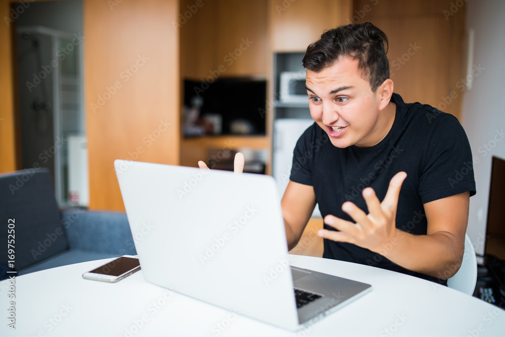 Angry Self employed businessman working from home on laptop Angry Self employed businessman working from home on laptop
