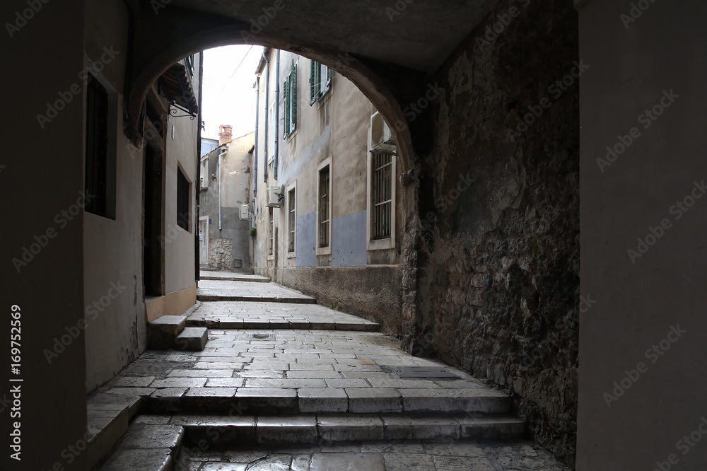 Fototapeta premium Sibenik / Tourist city by the Adratic sea - Sibenik, Croatia. The old stones, narrow street and stairs.