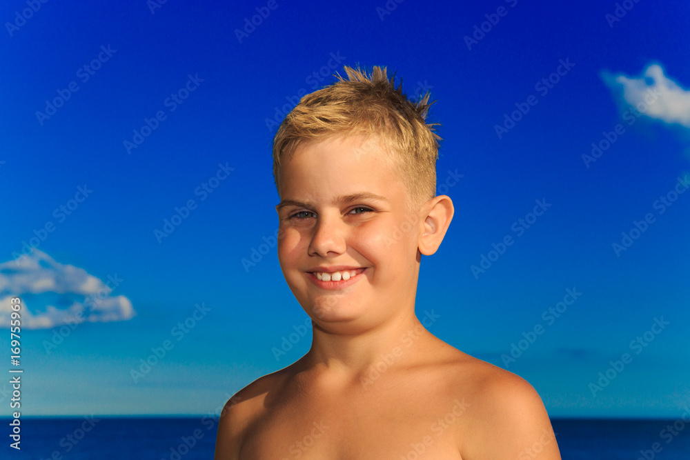 Portrait of a boy on a blue sea background