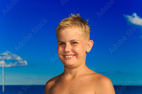 Portrait of a boy on a blue sea background © natatretiakova