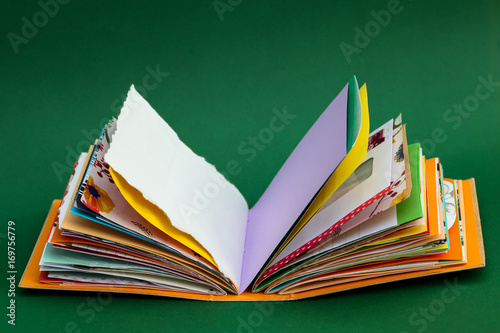 A colorful, handmade junk journal. Made from a recycled box and random paper such as book pages, envelopes and wall paper. Five signatures are stitched in with red thread.