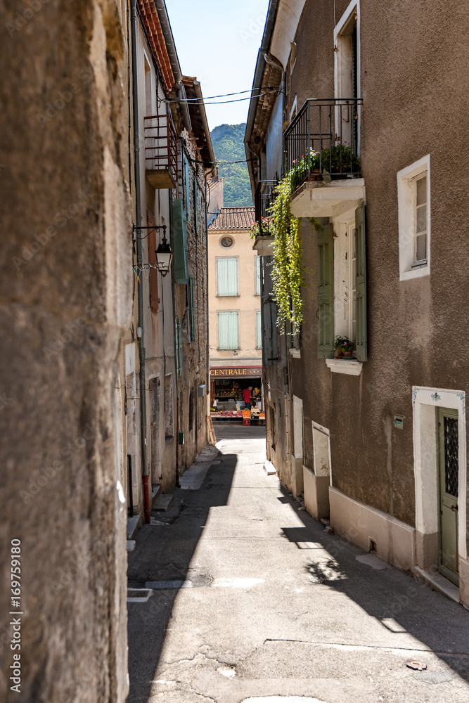 Authentic French town with narrow streets, colorful houses and atmospheric flowers.