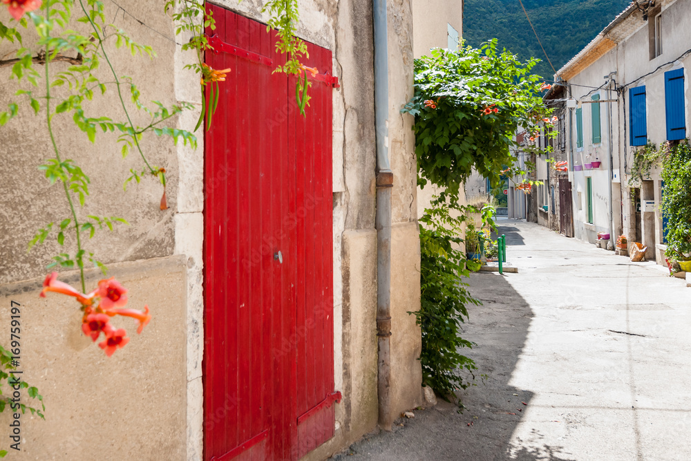 Fototapeta premium Authentic French town with narrow streets, colorful houses and atmospheric flowers.