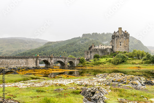 Eilean Donan castle in Highlands mountains in Scotland photo