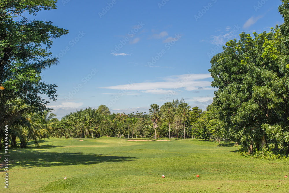 Green golf field par 3 and blue cloudy sky. Green golf field par 3 and blue cloudy sky.