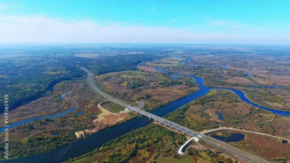 Aerial view of bridge over river and highway road. Drone view of road bridge over water. River aerial view. Aerial landscape. Highway road bridge over river. Drone view of highway road landscape Aerial view of bridge over river and highway road. Drone view of road bridge over water. River aerial view. Aerial landscape. Highway road bridge over river. Drone view of highway road landscape