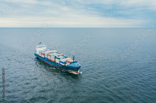 Aerial view of container vessel sailing in open sea