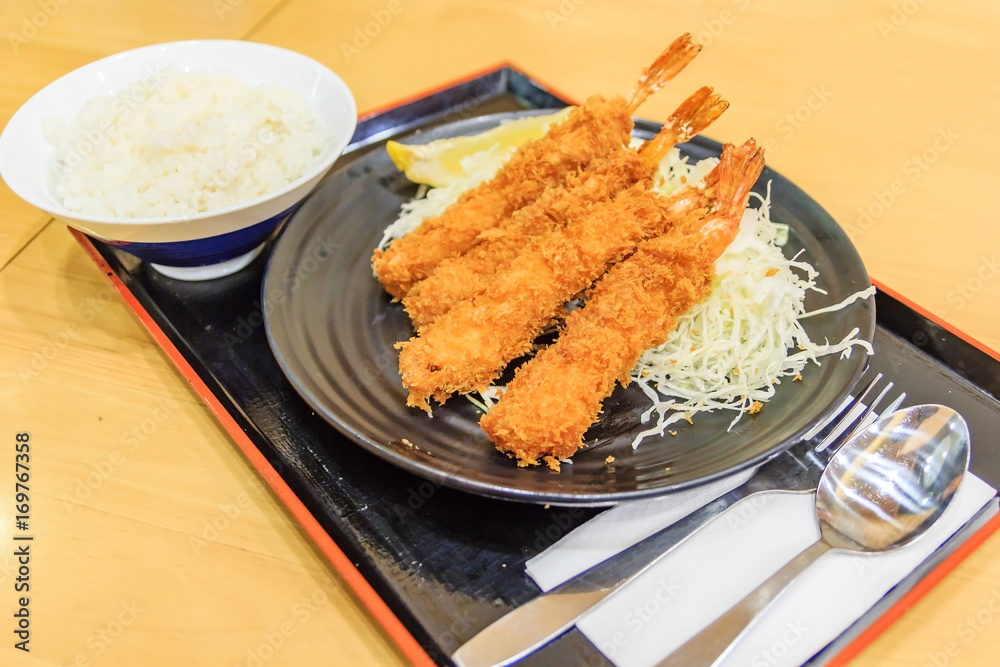 Japanese deep fried shrimp or tonkatsu set with rice on wooden table Japanese deep fried shrimp or tonkatsu set with rice on wooden table