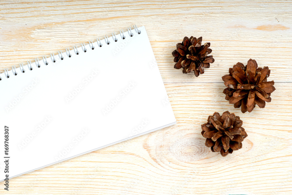 notepad with pine cones on white wooden planks, autumn card template notepad with pine cones on white wooden planks, autumn card template