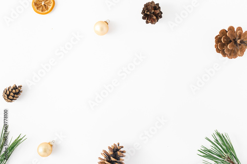 Frame of fir branch, pine cones, dry orange, Christmas balls