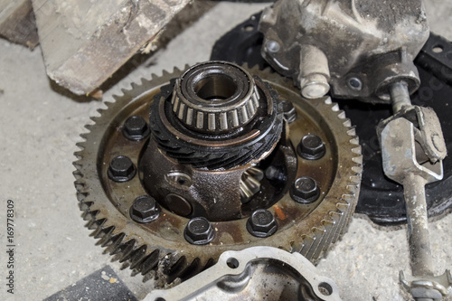 Dismantled box car transmissions. The gears on the shaft of a mechanical transmission.