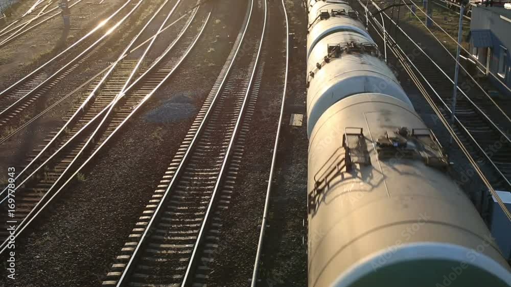 Freight train passing by at sunset