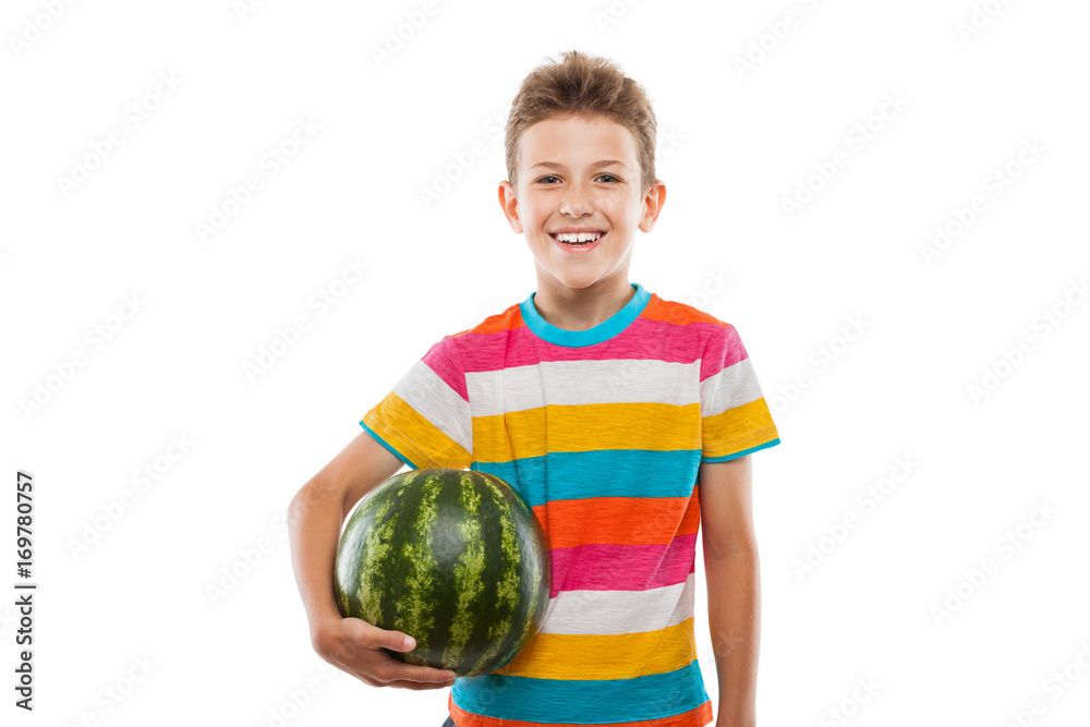 Handsome smiling child boy holding green watermelon fruit