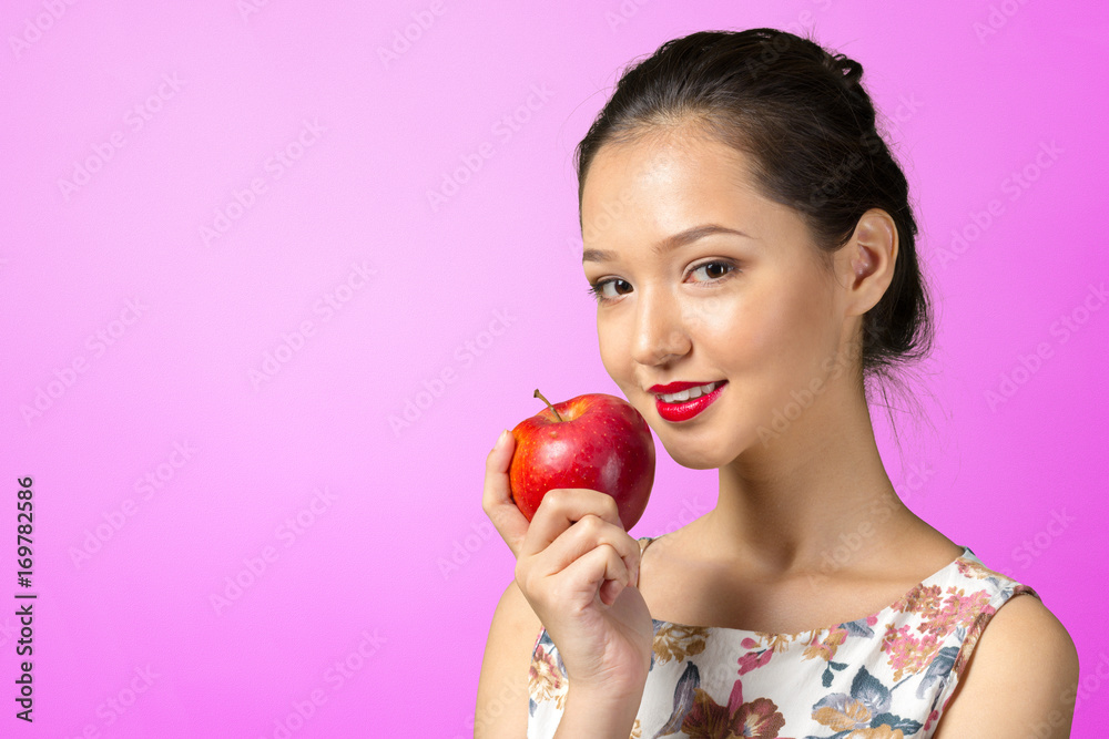 Smiling woman holding red apple