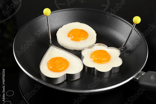 Cooking of delicious sunny side up eggs in molds