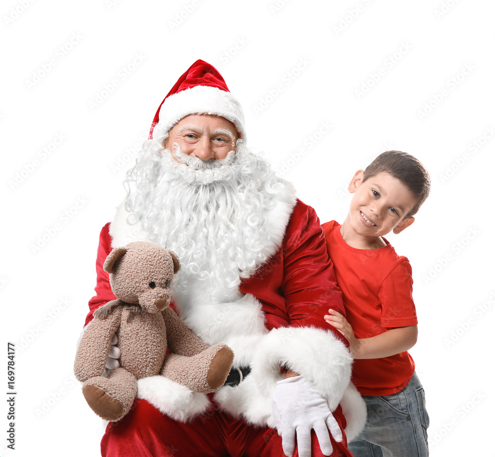 Cute boy and authentic Santa with teddy bear against white background Cute boy and authentic Santa with teddy bear against white background
