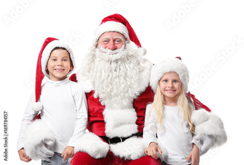 Cute kids in Christmas hats and authentic Santa Claus on white background
