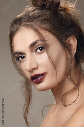 Portrait of beautiful girl with clean skin and smearing lipstick. Feathery lips and a strand of hair