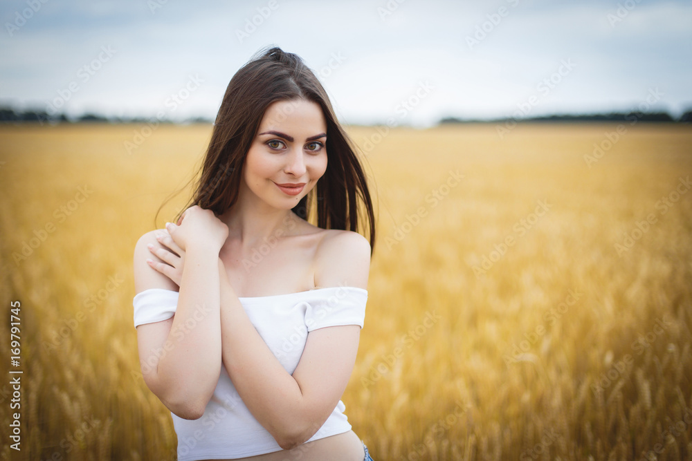 Beautiful woman girl looking at camera. close-up to very beautiful girl with amazing green eyes red lips and attractive face. cute amazing portrait in the field of wheat. birthmark on the face Beautiful woman girl looking at camera. close-up to very beautiful girl with amazing green eyes red lips and attractive face. cute amazing portrait in the field of wheat. birthmark on the face