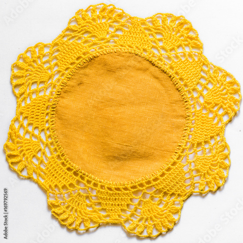 Yellow handmade lace tablecloth texture on white background