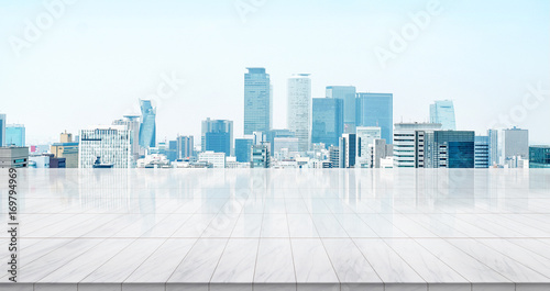 Business concept - Empty marble floor top with panoramic modern cityscape building bird eye aerial view under sunrise and morning blue bright sky of Nagoya, Japan for display or montage product photo