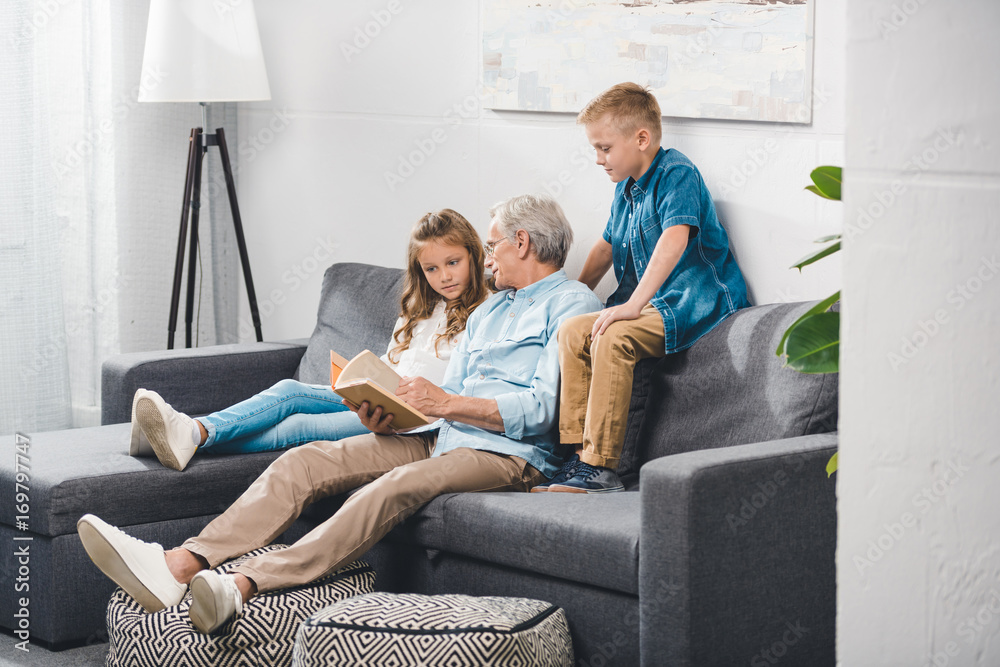 grandfather and grandchildren reading book grandfather and grandchildren reading book