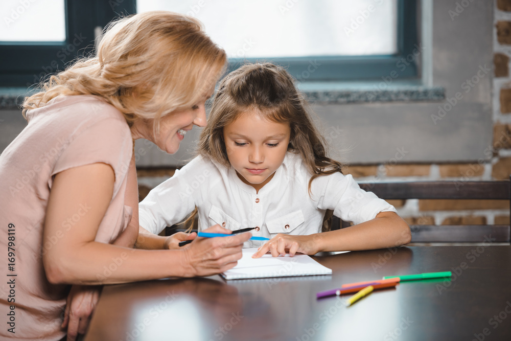 grandmother and granddaughter drawing together grandmother and granddaughter drawing together