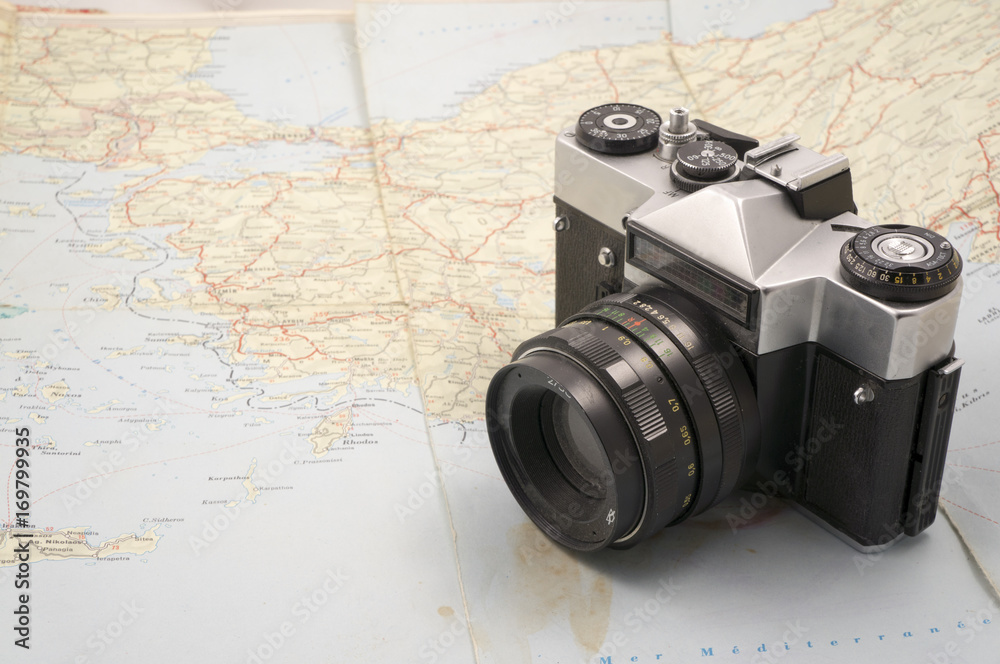 Old film camera on a map.