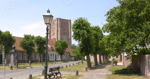 Village green with water pump of Sint Anna ter Muiden, a medieval town that was granted city rights in 1242, located on the westernmost point of the Netherlands in Zeelandic Flanders. photo