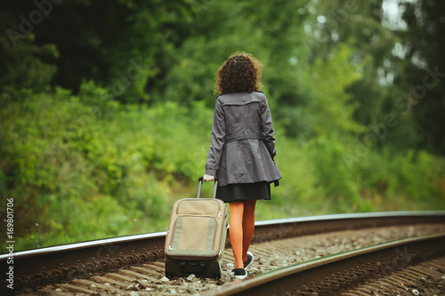 girl traveling on train rails 