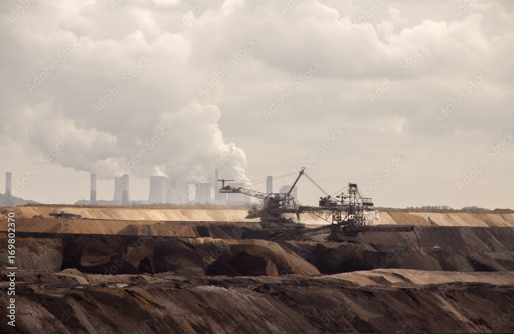 Fototapeta premium Germany, North Rhine Westphalia, -june 2017: ground excavator in action moving mullock and soil at open pit coal mine; Germany,for winning brown coal