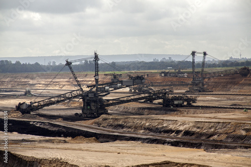 Germany, North Rhine Westphalia, -june 2017: ground excavator in action moving mullock and soil at open pit coal mine; Germany,for winning brown coal