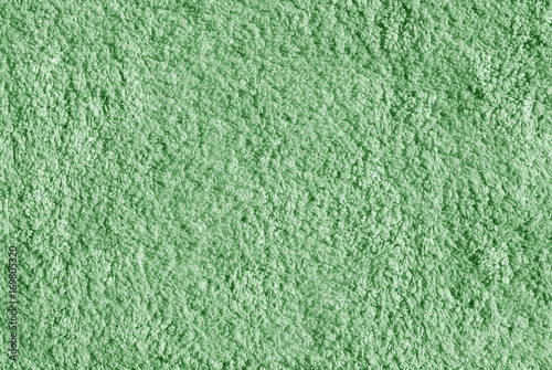 Green color bath towel surface.