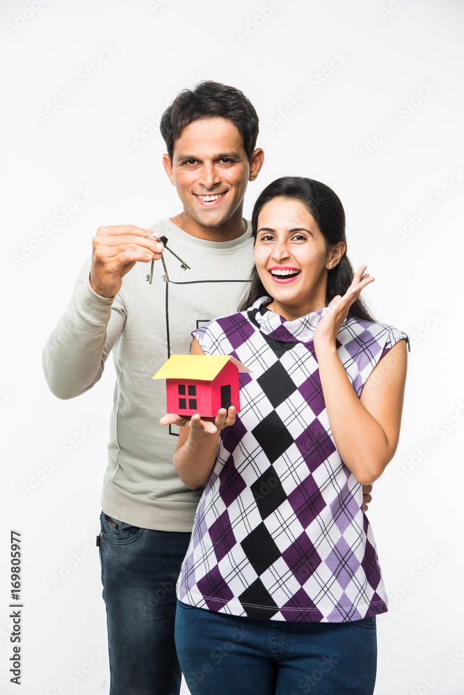 stock photo of Indian smart and cheerful / happy couple holding 3D ...