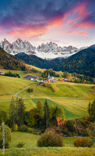 Magnificent view of Santa Maddalena village in front of the Geisler or Odle Dolomites Group. Colorful autumn sunset in Dolomite Alps, Italy, Europe. Artistic style post processed photo.