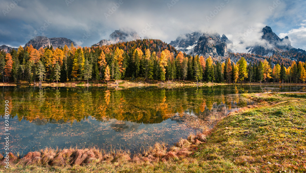 Fototapeta premium Sunny outdoor scene on Antorno lake. Colorful autumn morning in Dolomite Alps, National Park Tre Cime di Lavaredo, Italy, Europe. Artistic style post processed photo.