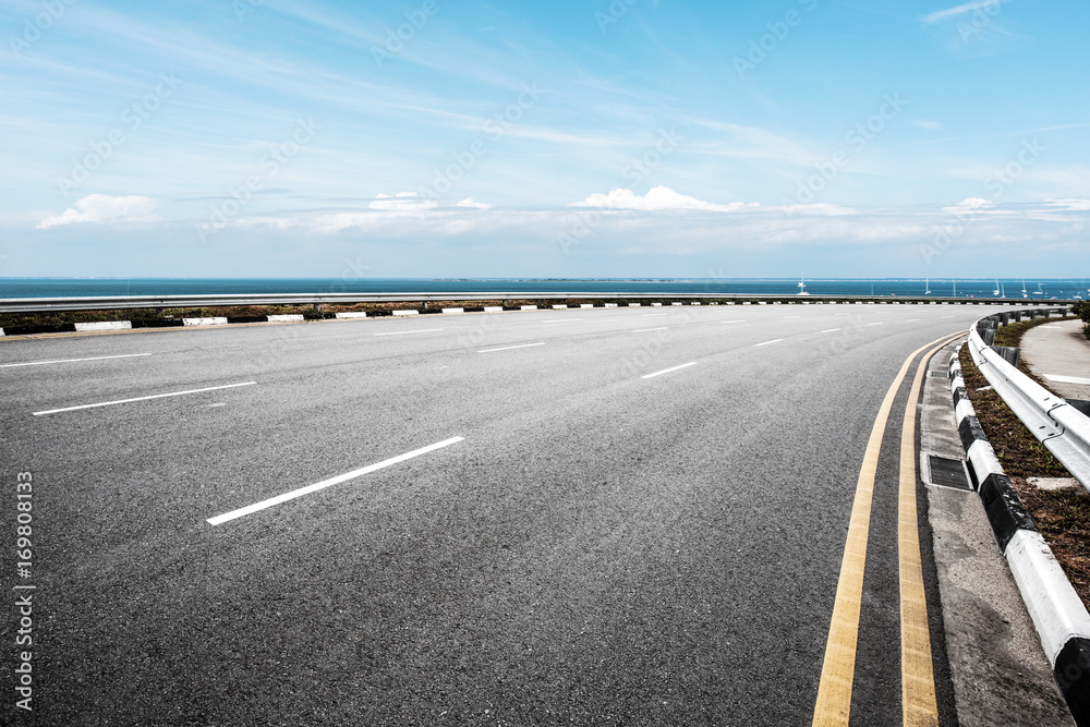 Fototapeta premium empty road with blue sea in blue sky