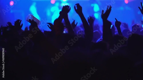 Slow motion concert crowd dancing at life music concert