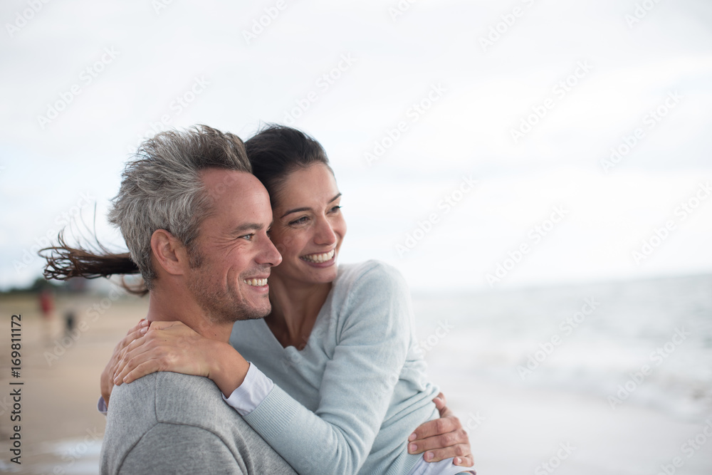  middle-aged couple walking on the beach