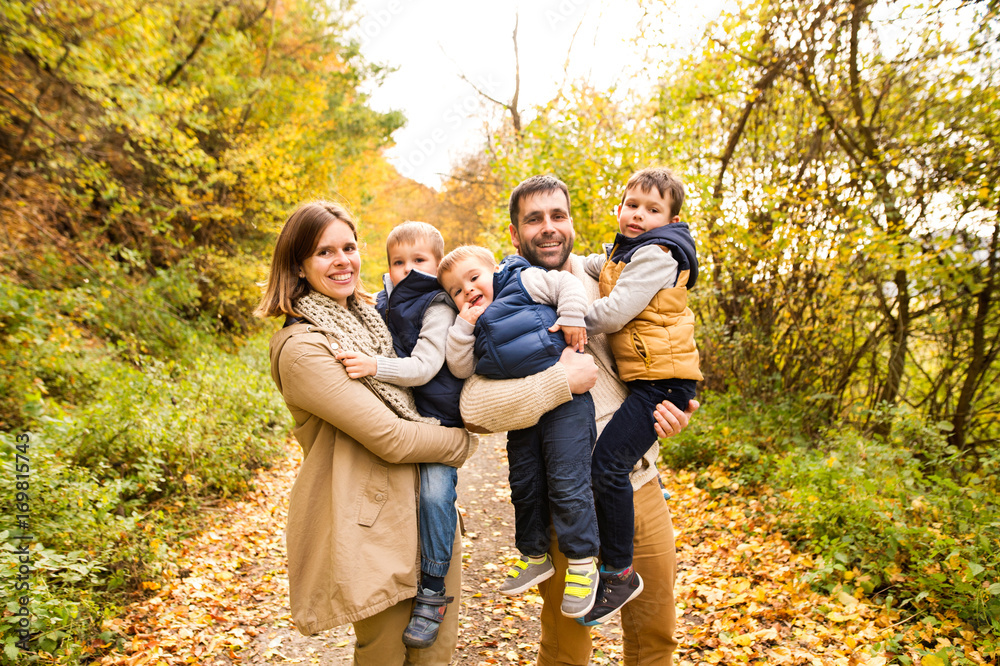 Beautiful young family on a walk in autumn forest. Beautiful young family on a walk in autumn forest.