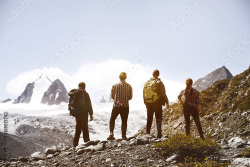 Group four friends trekking mountains