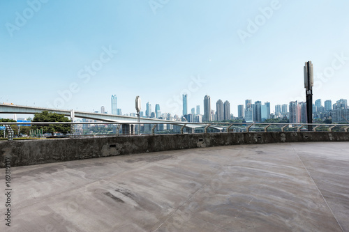 empty concrete road with cityscape of modern city in blue sky