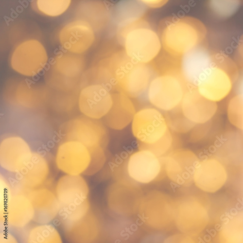 Golden Christmas background with natural  bokeh and twinkled defocused lights. Festive blur background . © nataliazakharova