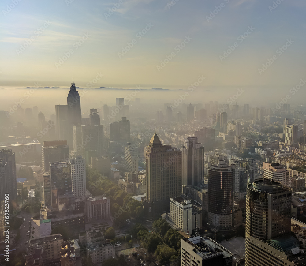 Nanjing city with sunrise and morning mist from high angle.