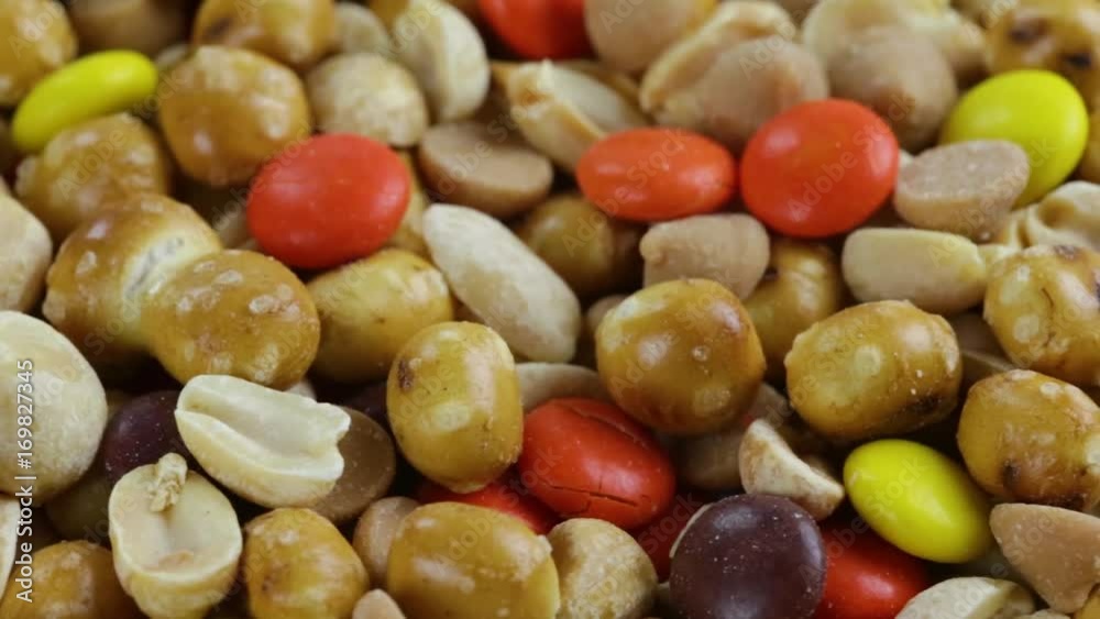 A very close panning video of peanut butter chips with candy and pretzel pieces.. A very close panning video of peanut butter chips with candy and pretzel pieces..