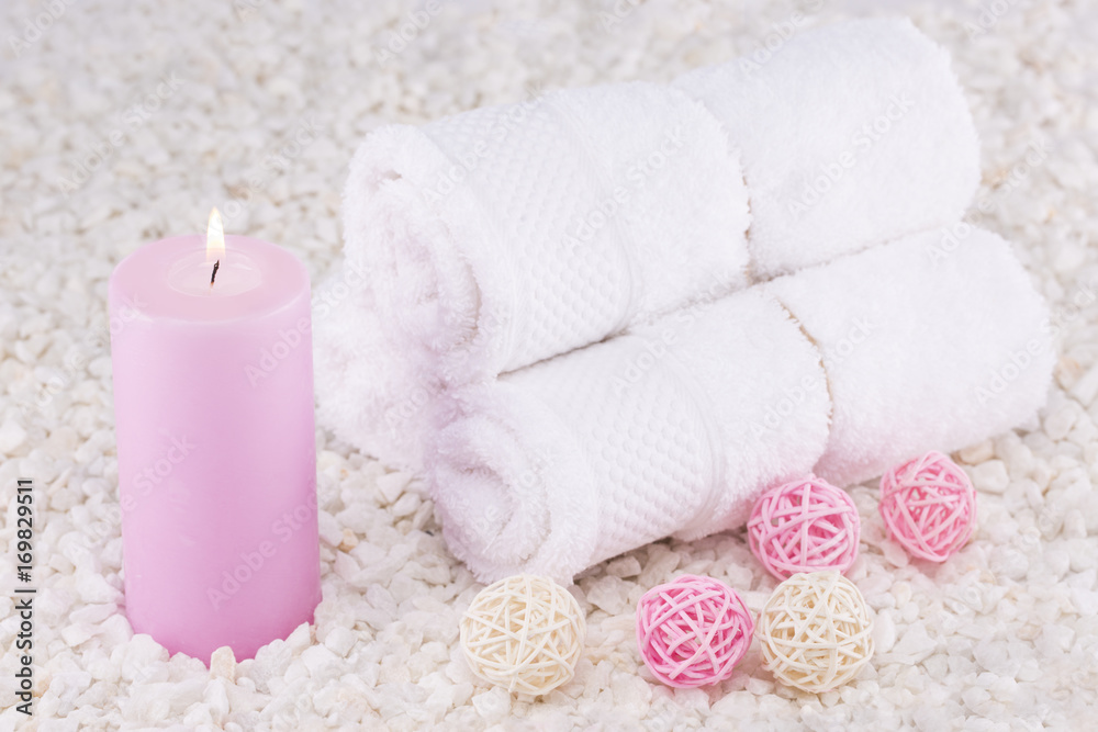 Spa. Still life. Towels rolled up, a pink candle Spa. Still life. Towels rolled up, a pink candle