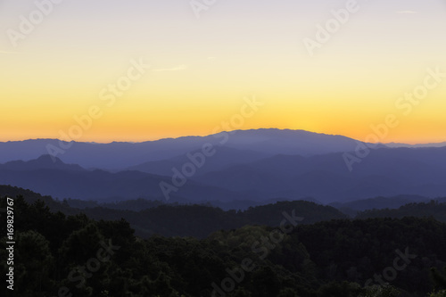 The mountains of layer in the sunset and mist in golden hour sky © uaychai