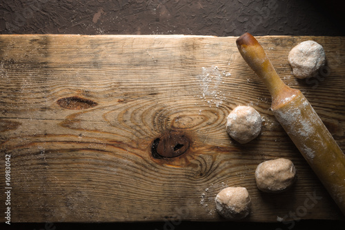 Cooking Indian bread chapati on the wooden table top view photo