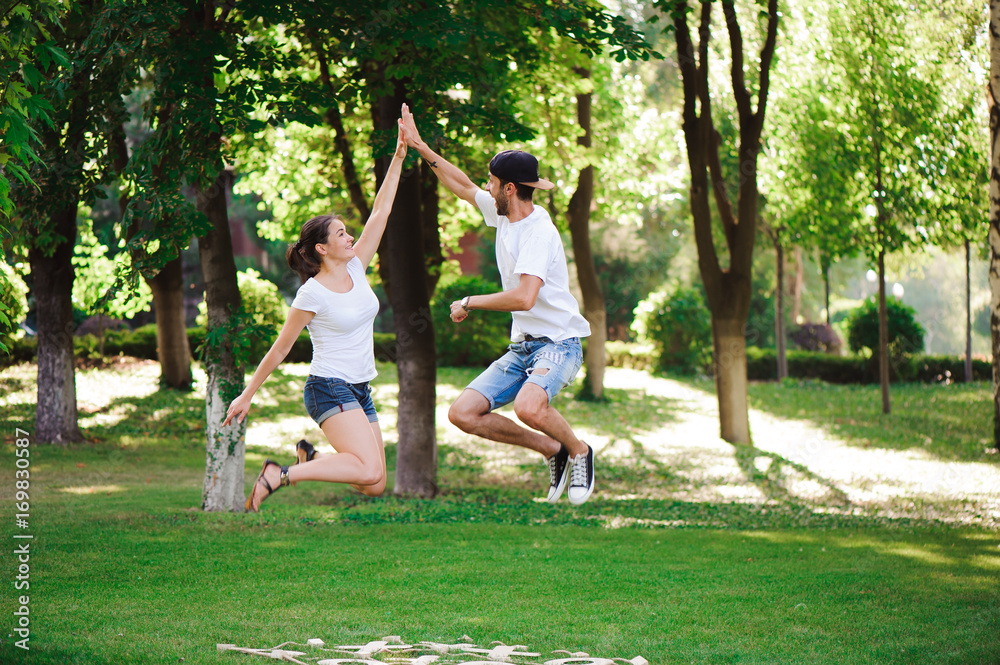 A young couple celebrate victory playing tic-tac-toe in the park A young couple celebrate victory playing tic-tac-toe in the park